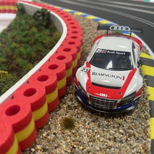 Load image into Gallery viewer, Audi R8 im Kiesbett mit Reifenstapel rot gelb